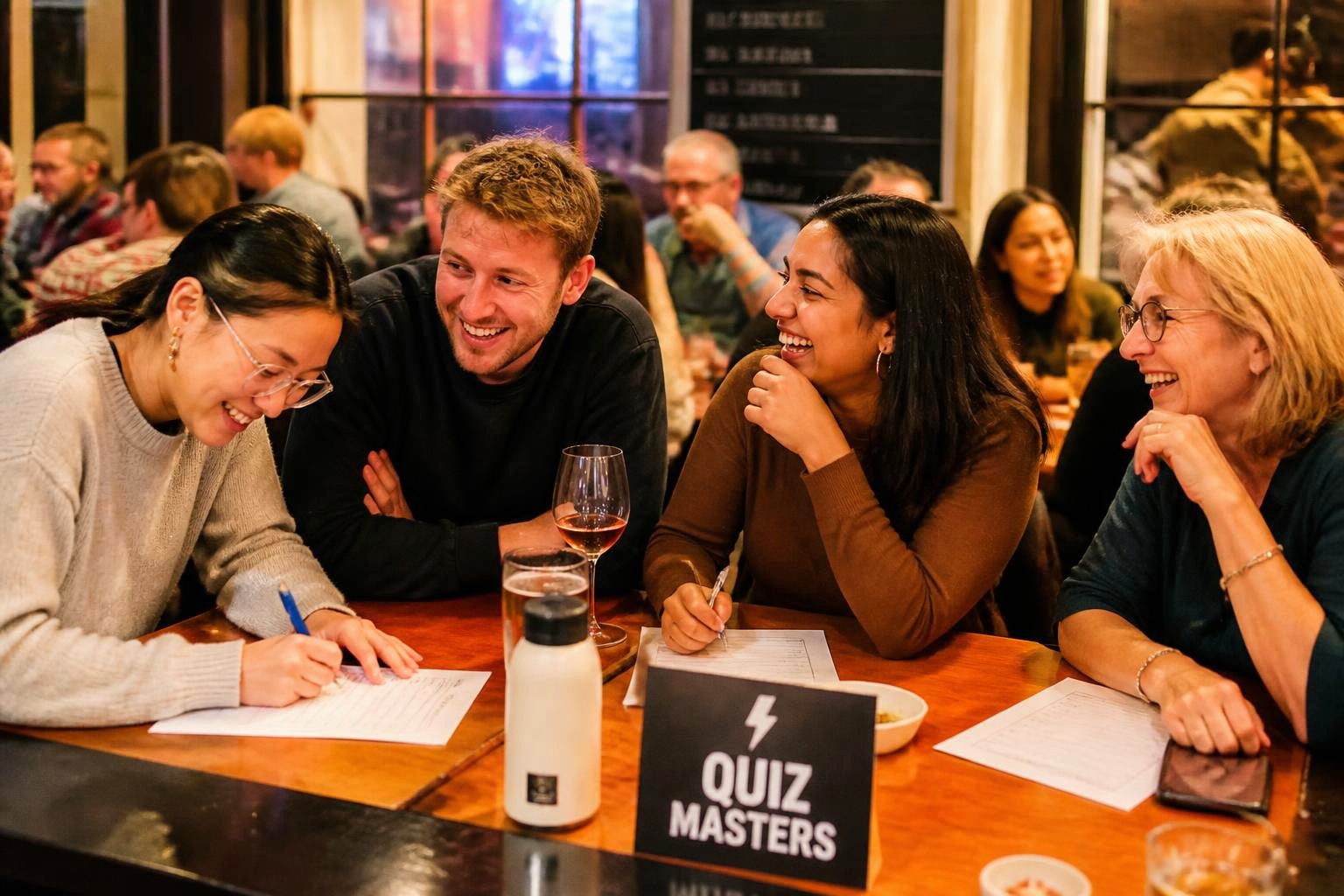 A small welcoming group at a pub trivia night, warmly including someone new